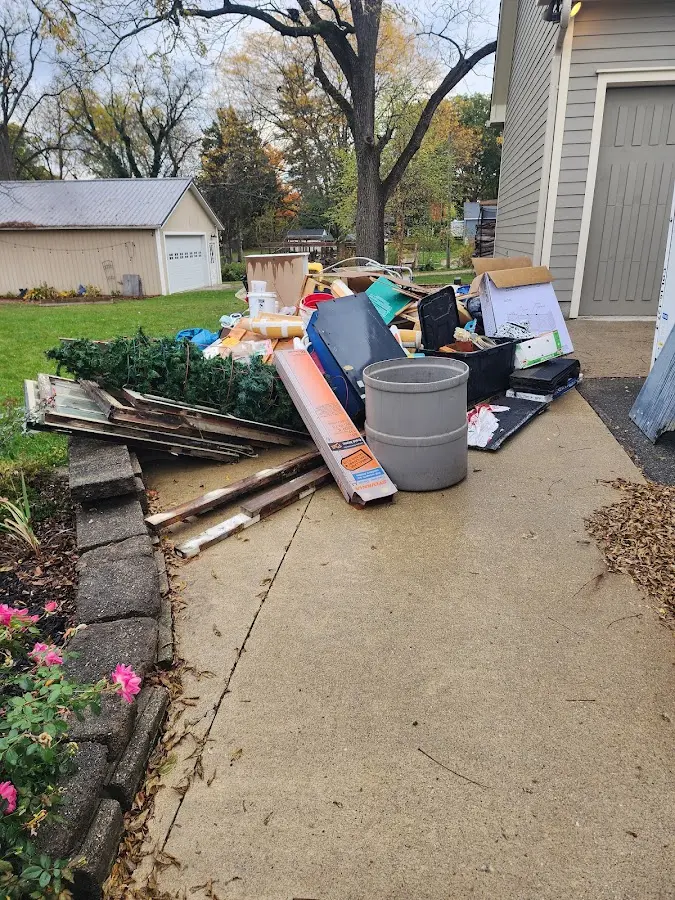 Dumpster being loaded with debris for Roofing Dumpster Rental in Atmore
